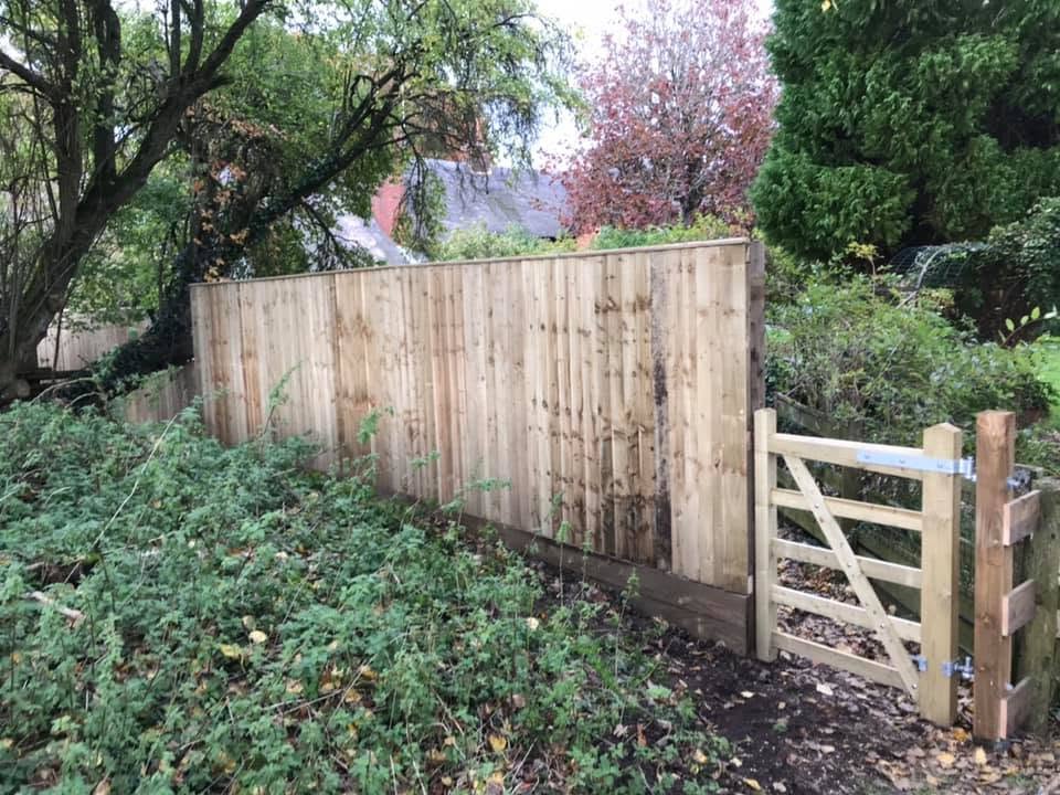 New closeboard fence finished with a five-bar timber field gate