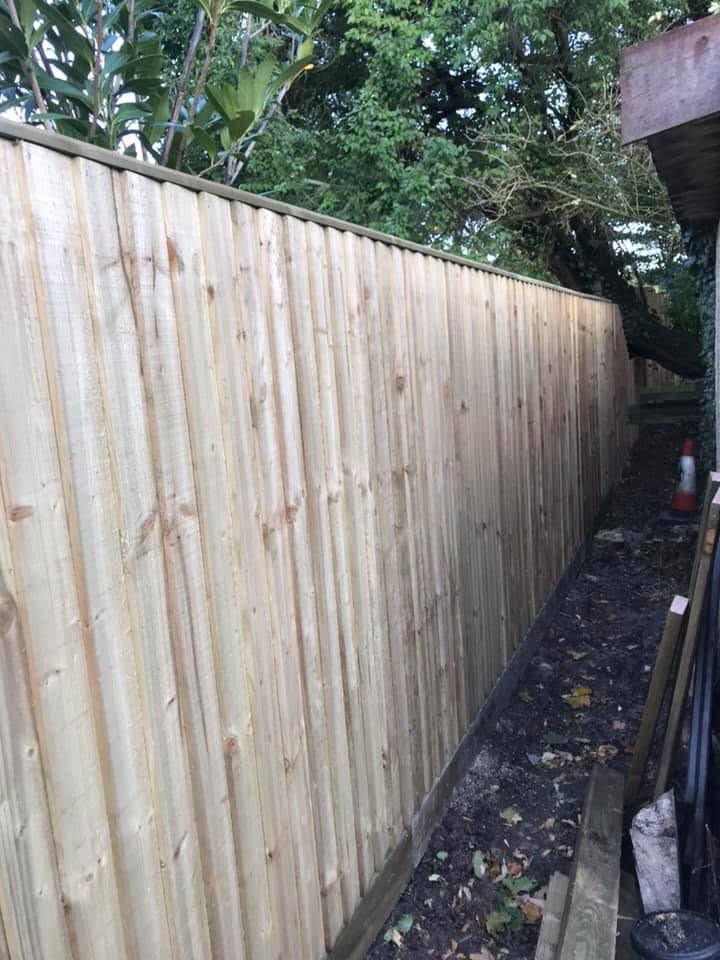 A long run of new closeboard fencing down a side passage